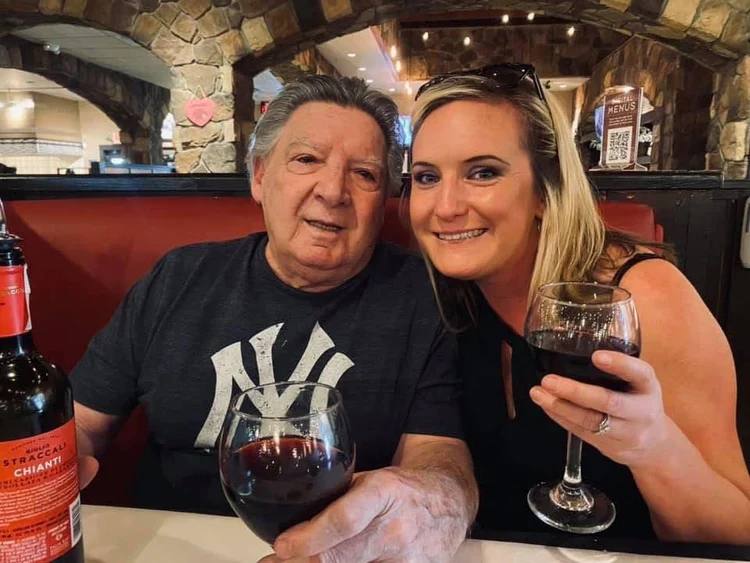 Papa and Gina sharing wine at restaurant